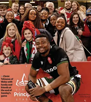  ?? ?? Christ Tshiunza of Wales with family and friends at the end of Sunday’s game