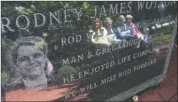  ?? (File Photo/AP/Mel Evans) ?? Pat Wotton (left) is reflected in September 2012 in a memorial to her husband, Rodney James Wotton, as she sits with Dorothy Greene (second left), Jean Wotton, Rodney’s mother, and Eunice Saporito (right), in Middletown, N.J. The marker for Rodney Wotton is one of 37 in the Middletown World Trade Center Memorial Gardens for those from the town in central New Jersey who died in the attack on the World Trade Center in 2001.