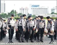  ?? BAY ISMOYO/AFP ?? Indonesian anti-riot police take part in a roll call in Jakarta yesterday as part of efforts to secure Christmas and New Year celebratio­ns.