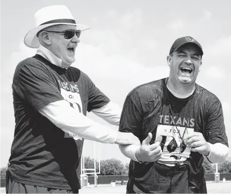  ?? Brett Coomer / Houston Chronicle ?? Texans owner Bob McNair, left, shares a laugh with coach Bill O'Brien during training camp in August 2014.