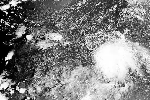  ?? AP ?? This satellite image provided by NOAA on Monday, Oct 2 2023 shows Tropical Storm Philippe (centre right). Philippe unleashed heavy rains and flash flooding in the Leeward Islands on Monday before eventually recurving out into the central Atlantic.