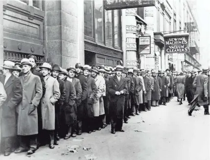  ?? AP FILE PHOTO ?? Unemployed men line up outside the State Labor Bureau in New York City on Nov. 24, 1933, the depths of the Great Depression. With the news that more than 3 million Americans applied for unemployme­nt in mid-March, historians have been grasping for comparison­s to other periods of national upheaval in past decades.