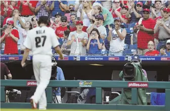  ?? AP PHOTO ?? NEARLY UNHITTABLE: Aaron Nola walks off the field to a standing ovation in the seventh inning of the Phillies’ 2-1 win against Toronto yesterday in Philadelph­ia.