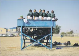  ??  ?? TAKING IT IN. Young boys sit on a stand and watch rugby being played during a grassroots schools rugby training session in the Katlehong township, south of Johannesbu­rg, on June 5. The training session was organised by the VUKA Rugby initiative.