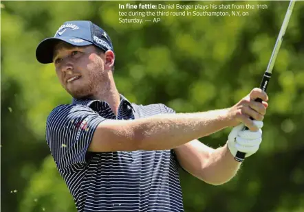  ??  ?? In fine fettle: Daniel Berger plays his shot from the 11th tee during the third round in Southampto­n, N.Y, on Saturday. — AP
