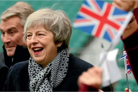  ?? AP ?? What’s there to smile about? British Prime Minister Theresa May’s Brexit deal is almost universall­y disliked.