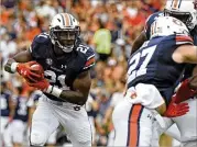  ?? THOMAS GRANING / ASSOCIATED PRESS ?? With 12 touchdowns, running back Kerryon Johnson (left) is a key piece of a potent Auburn offense that has emerged during SEC play.