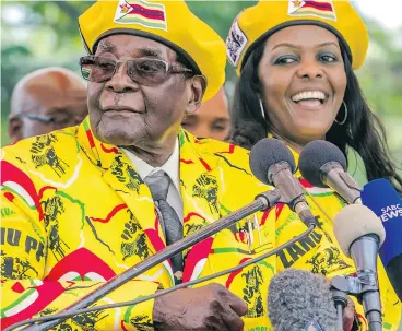  ?? JEKESAI NJIKIZANA / AFP / GETTY IMAGES ?? Zimbabwe President Robert Mugabe called on party members to support wife Grace Mugabe, right, as the party’s next vice-president at a rally last week.