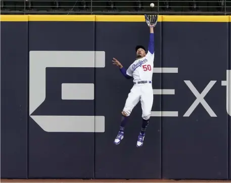  ?? Ap ?? FOR THE LOVE OF ELEVATION! Mookie Betts rises up to rob Marcell Ozuna of extra bases during the Dodgers’ 3-1 win over Atlanta in Game 6 of the NLCS yesterday.