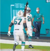 ?? JOHN MCCALL/SOUTH FLORIDA SUN SENTINEL ?? Dolphins’ Salvon Ahmed celebrates after scoring a touchdown Sunday.