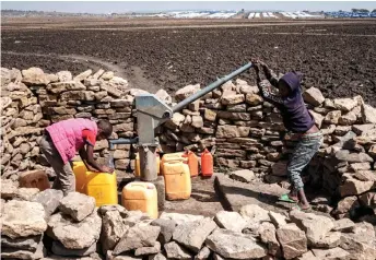  ?? — AFP photo ?? Boys fetch water near the newly built internally displaced person camp which will host about 19000 people in Mekele, the capital of Tigray region, Ethiopia.