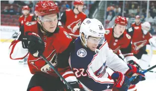  ?? RICK SCUTERI/THE ASSOCIATED PRESS ?? The Arizona Coyotes loaned centre Barrett Hayton, left, to the national team. In 14 games with the Coyotes, Hayton has one goal and three assists.