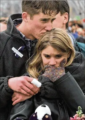  ?? BEBETO MATTHEWS / AP ?? Shooting victim Austin Eubanks, then 17, hugs his girlfriend at a community-wide memorial service in Littleton, Colo., for the victims of the shooting rampage at Columbine High School. Recovery took a long dark turn for Eubanks after he watched his...