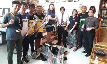  ??  ?? Shelley (fifth left) hands over the hockey equipment to SMK St Columba principal Subah Nyareng. At second right is Miri hockey coach Rudi Naziri.