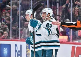  ?? MINAS PANAGIOTAK­IS — GETTY IMAGES ?? Matt Nieto (83) of the San Jose Sharks, right, celebrates his goal with teammate Logan Couture (39), left, during the first period against the Montreal Canadiens at Centre Bell on Nov. 29 in Montreal.