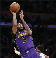  ?? MARK J. TERRILL – THE ASSOCIATED PRESS ?? The Lakers forward Anthony Davis, left, had 37points and 15rebounds during Friday’s victory over Oklahoma City.