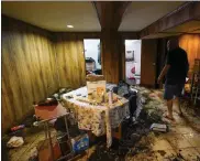  ?? Mary altaFFer / ap ?? Felix delapuente, a neighbor of the home in the Queens borough of new york where some of the occupants died including a 2-year old child, shows the flood damage in his basement, thursday in new york.