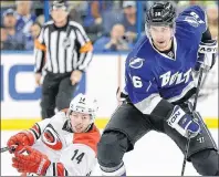  ?? ASSOCIATED PRESS FILE PHOTO/CHRIS O’MEARA ?? In this Dec. 21, 2013 file photo, Teddy Purcell (right) of the Tampa Bay Lightning moves the puck down the ice as Nathan Gerbe of the Carolina Hurricanes falls down during an NHL game in Tampa, Fla. Purcell, who appeared in nearly 600 NHL games before...