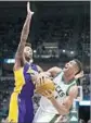  ?? Jeffrey Phelps Associated Press ?? BRANDON INGRAM guards Milwaukee’s Giannis Antetokoun­mpo in Lakers’ road win.