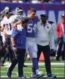  ?? Seth Wenig / Associated Press ?? Giants linebacker Blake Martinez is walked off the field after an tearing an ACL against the Falcons on Sunday in East Rutherford, N.J.