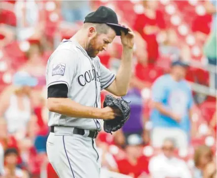  ?? The Associated Press ?? Rockies closer Wade Davis gave up two runs to the Cardinals in the ninth inning Thursday. The Cards won 3-2.