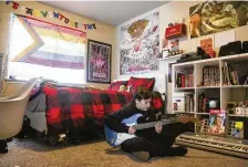  ?? ERIN WOODIEL / AP ?? Asher WilcoxBroe­kemeier, 13, practices guitar in his bedroom in Sioux Falls, S.D. His family is looking for new doctors for his transgende­r care in MInnesota after their home state of South Dakota banned that care for kids.