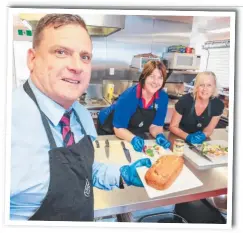  ?? Picture: TIM MARSDEN ?? Aquinas College assistant principal Joe Alexander, canteen manager Lisa Whitehouse and Joanne Heath prepare meals for their Friday Free Feedz event.