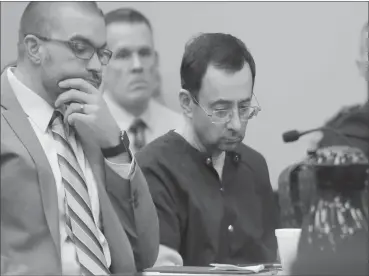  ?? Associated Press ?? ■ Larry Nassar sits with attorney Matt Newburg during his sentencing hearing Wednesday in Lansing, Mich. The former sports doctor who admitted molesting some of the nation’s top gymnasts for years was sentenced Wednesday to 40 to 175 years in prison as...