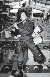  ?? Courtesy photo / NASA ?? Mission Specialist Ellen Ochoa plays the flute in space aboard shuttle Discovery in April 1993.