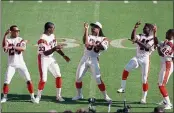  ?? AL BEHRMAN — THE ASSOCIATED PRESS FILE ?? Cincinnati Bengals fullback Ickey Woods, center, and teammates do their dance for the media at Super Bowl Media Day in Miami.