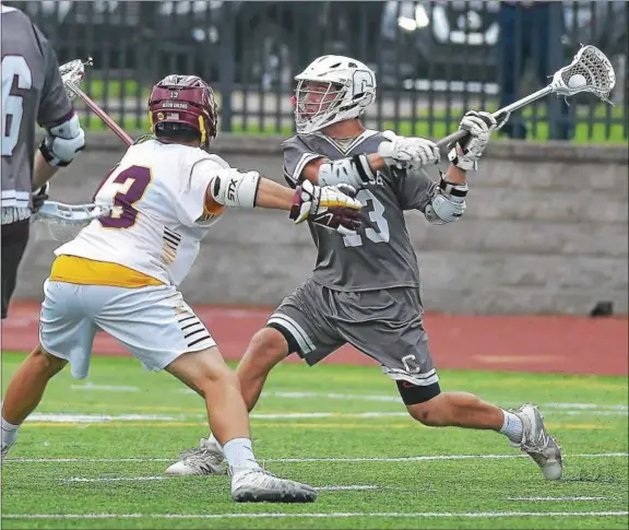  ?? PETE BANNAN — DIGITAL FIRST MEDIA ?? Above, Conestoga’s Cliff Madden (13) fires in a second half goal against Avon Grove Saturday night at West Chester Henderson. Below, Avon Grove’s Jason Lengel (23) and Conestoga’s Jackson Niness (21) mix it up in the second half.