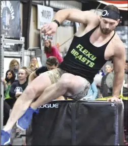  ?? Staff photo/ Teresa Dowling ?? Ansonia’s Casey Bruns vaults over a 48-inch box as part of an exercise during the Winter Classic. Bruns’ team, Flexy Beasts, finished second in the male RX Division.