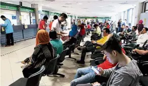  ??  ?? Overcrowde­d: Business will be easier at the Immigratio­n counters like this one in Putrajaya once MyOnline Passport comes online.