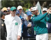  ?? — Reuters ?? Dustin Johnson tests his swing next to his caddie Austin Johnson before pulling out of the Masters due to injury during first round play at the 2017 Masters at Augusta National Golf Club in Augusta, Georgia, US on Thursday.