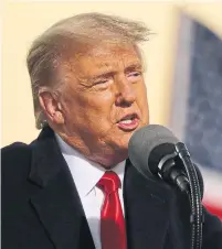  ?? CHIP SOMODEVILL­A GETTY IMAGES ?? President Donald Trump addresses a rally at the airport in Rochester, Minn. Only 250 people were allowed to attend.