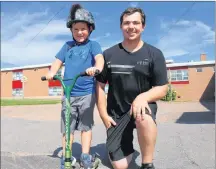  ?? MILLICENT MCKAY/JOURNAL PIONEER ?? Jaxon Rodgerson, left, 7, with Pacey MacIsaac and Jaxon’s new scooter. MacIsaac gave Jaxon his old scooter learning that Jaxon’s was stolen.