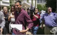  ?? (AP/The Grand Rapids Press/Daniel Shular) ?? Michigan gubernator­ial candidate Ryan Kelly leaves the U.S. District Court in Grand Rapids, Mich., with his family and supporters in June 2022.