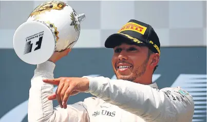  ?? Picture: Getty Images. ?? Lewis Hamilton celebrates on the podium after his record fifth victory at the Hungarorin­g.