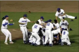  ?? NATI HARNIK — THE ASSOCIATED PRESS ?? Florida players celebrate after defeating LSU in Game 2 to win the NCAA College World Series baseball finals in Omaha, Neb., Tuesday.