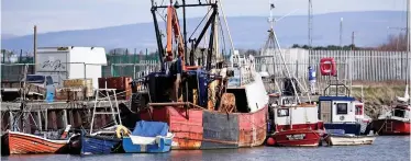  ??  ?? A struggling industry: A decommissi­oned fishing boat at Fleetwood in Lancashire