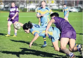  ?? PHOTO: LINDA ROBERTSON ?? University’s Matt Nicolson scores as he is tackled by Steven CampbellPa­niona, of South Pacific Raiders, during a Dunedin club rugby league match at the Kensington Oval on Saturday. Finn Langdale is in support.