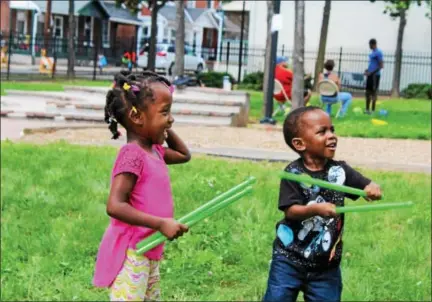  ?? MICHILEA PATTERSON — DIGITAL FIRST MEDIA ?? Amani Marshall, 4, and Jace Jones, 2, have a good time participat­ing in a fitness program that uses drum called Pound. The Pound activity was one of several fitness stations during the Pottstown Community Field Day at Chestnut Street Park on Saturday.