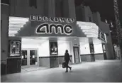  ?? MARCIO JOSE SANCHEZ AP ?? A shopper walks past a closed AMC movie theater Thursday in Santa Monica. The coronaviru­s pandemic has had a devastatin­g effect on the industry.