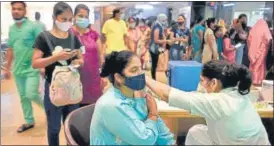  ?? ?? A woman gets a dose of Covid vaccine at Sector 30 district hospital in Noida on Monday.