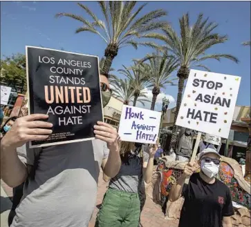  ?? Brian van der Brug Los Angeles Times ?? DEMONSTRAT­ORS gather to protest against racism on Garfield Avenue in Alhambra on March 21. The Black community is stepping up in solidarity after anti-Asian attacks, Erika D. Smith writes.