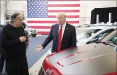  ?? STEPHEN CROWLEY/THE NEW YORK TIMES ?? President Donald Trump speaks with Fiat Chrysler CEO Sergio Marchionne at the American Center for Mobility near Ypsilanti, Michigan, on Wednesday.