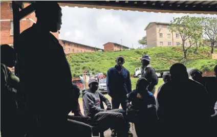  ??  ?? People affected by violence and intimidati­on meet at a garage in Glebelands, 25 October 2014. Photo: Rogan Ward