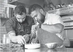  ??  ?? Chefs Roberto Centeno (left) and Rene Andrade prepare ceviche at Ghost Ranch.