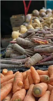  ?? KATIE WORKMAN ?? Root vegetables are displayed at the Union Square Farmers Market in New York on Jan. 8, 2021. Carrots, parsnips and other root vegetables are the stars of the farmers’ market during the middle of Winter, and a great way to add variety and nutrition to your cold weather meals.