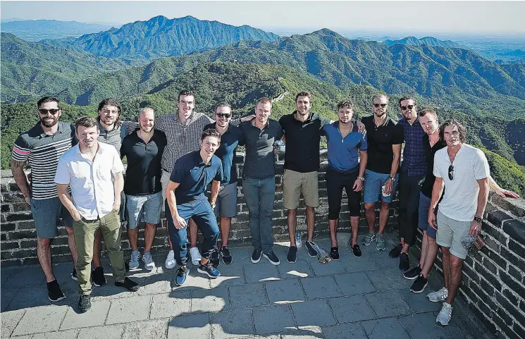  ?? — GETTY IMAGES ?? Canucks players assemble while climbing the Great Wall of China on Friday in Beijing. Vancouver Canucks and the Los Angeles Kings played two pre-season games in China last week, part of an effort by the National Hockey League to expand interest in hockey to new markets abroad and at home.